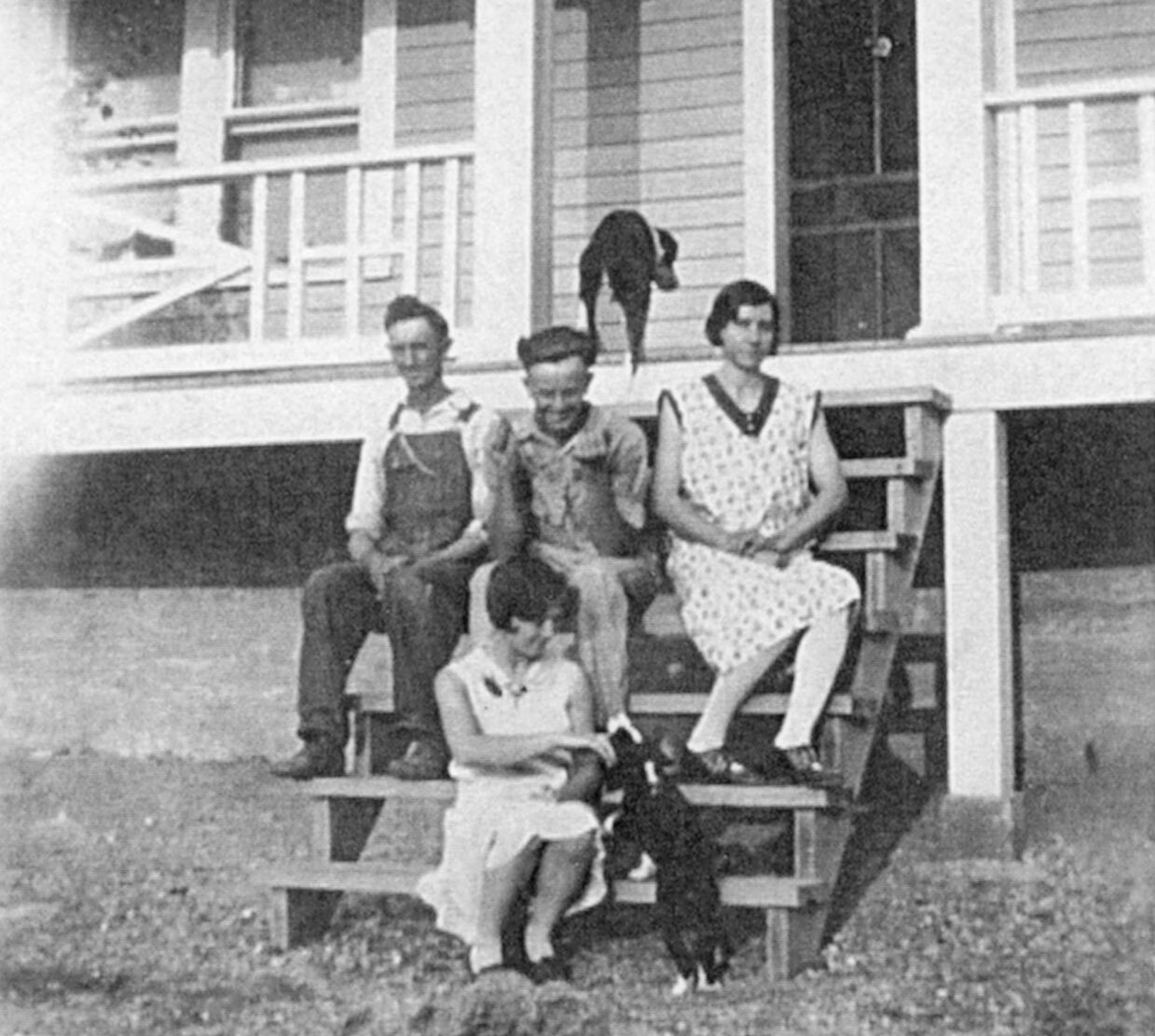 The Garrett Family sitting on the front steps of their house